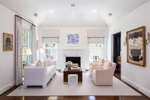 a living room with furniture a fireplace and a large window