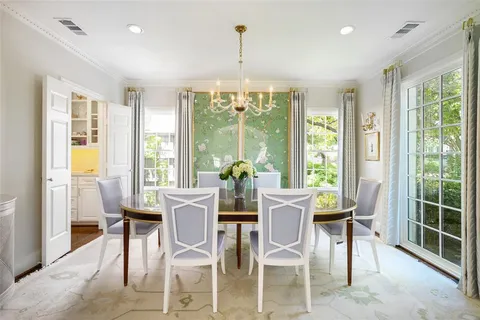 a view of a dining room with furniture large windows and wooden floor