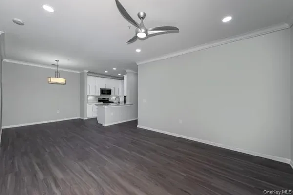 a view of a kitchen with a sink and wooden floor
