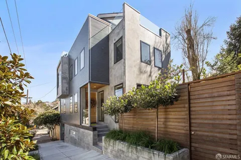 a view of a street with potted plants