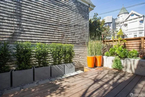 a wooden bench sitting in front of a building