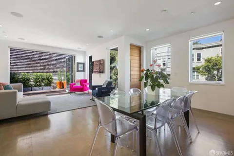 a dining room with furniture and a floor to ceiling window