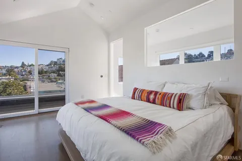 a bedroom with a large bed and a window