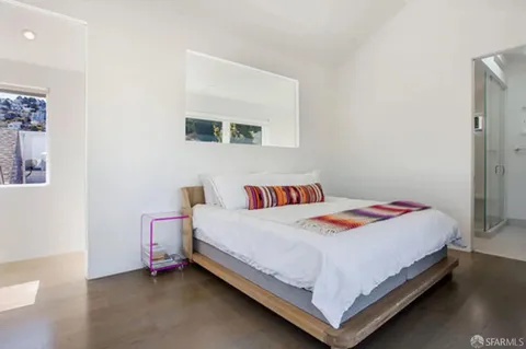 a bedroom with a bed and a lamp