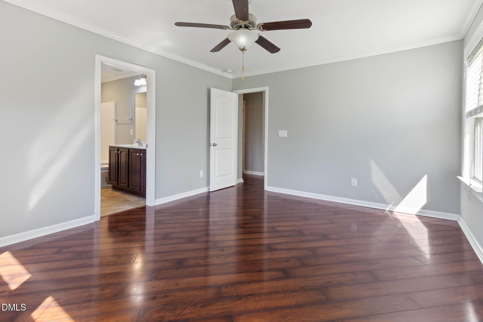 14303 Foxcroft Road Raleigh, NC 27614 - Photo 34 of 70 a view of an empty room with wooden floor and a ceiling fan