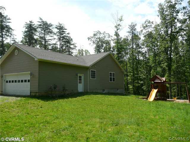 14309 Dry Bridge Road Ruther Glen, VA 22546 - Photo 2 of 4 a view of a backyard with a barn
