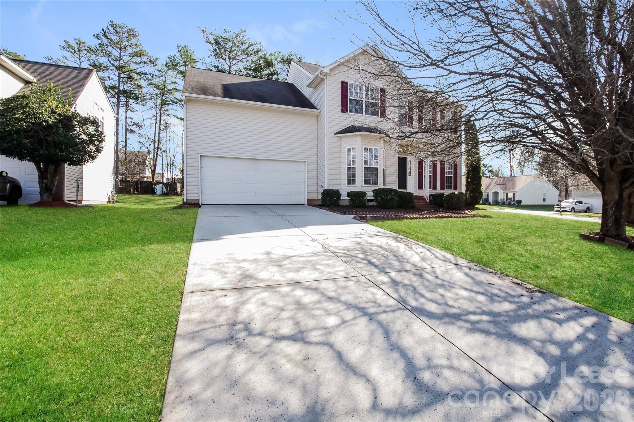 10802 Gold Pan Road Charlotte, NC 28215 - Photo 2 of 15 a view of a white house with a big yard and large tree