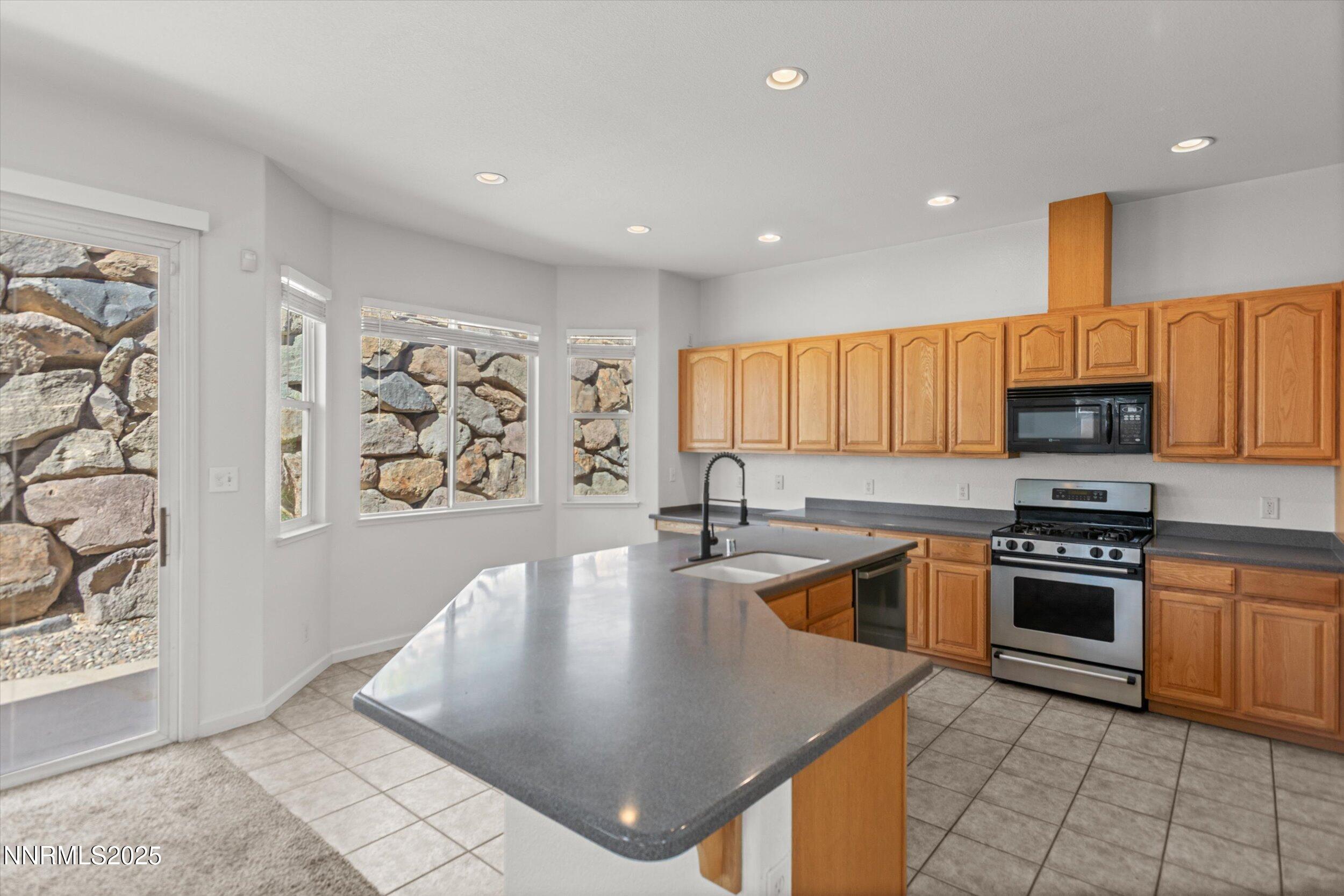 2365 Red Maple Court Reno, NV 89523 - Photo 11 of 34 a kitchen with stainless steel appliances granite countertop a sink a stove top oven a counter space and cabinets
