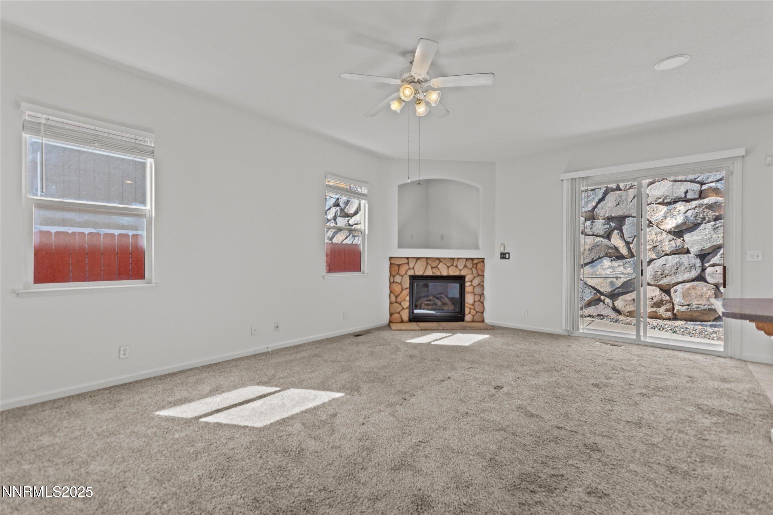 2365 Red Maple Court Reno, NV 89523 - Photo 13 of 34 an empty room with windows and fireplace