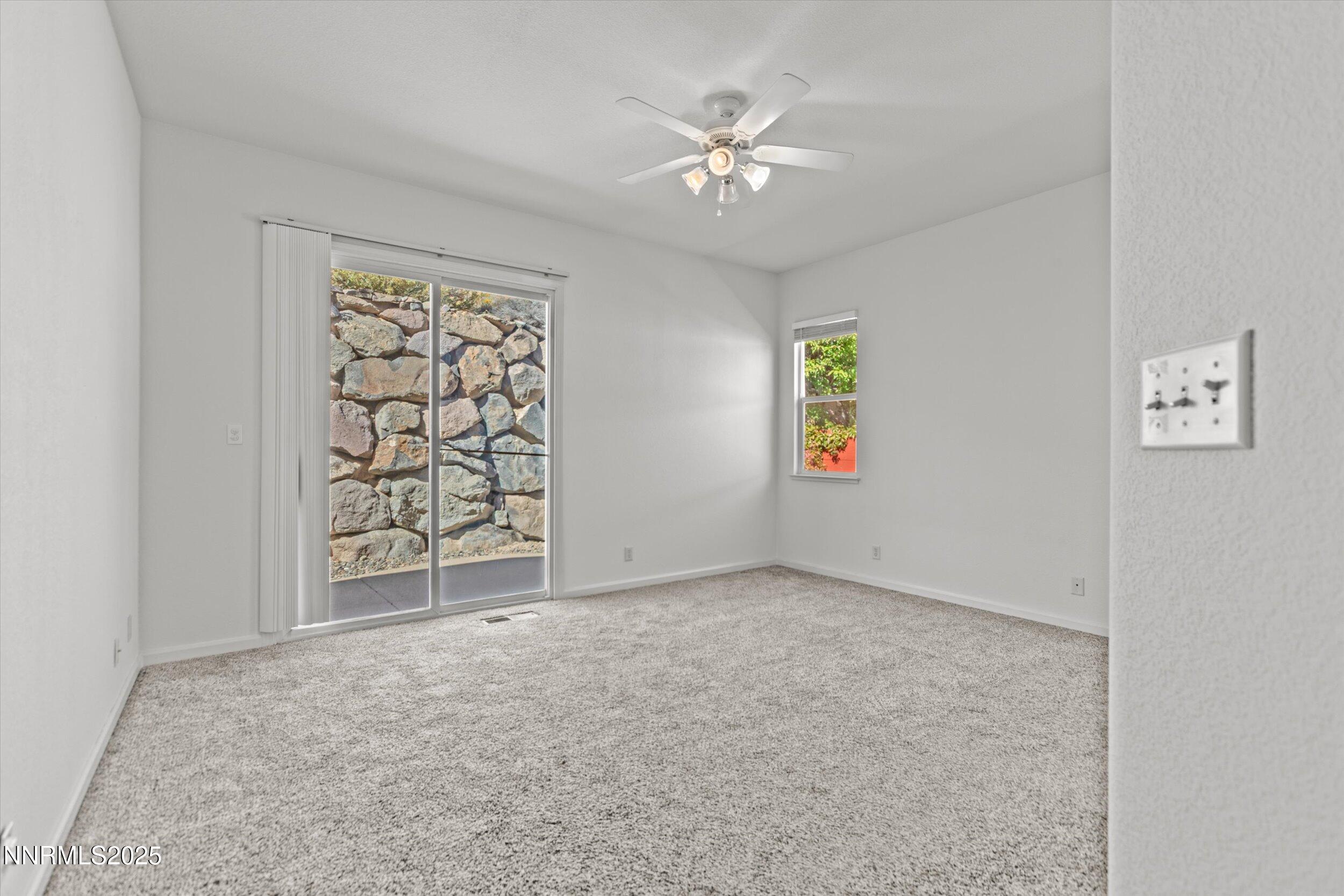 2365 Red Maple Court Reno, NV 89523 - Photo 24 of 34 an empty room with windows and chandelier fan