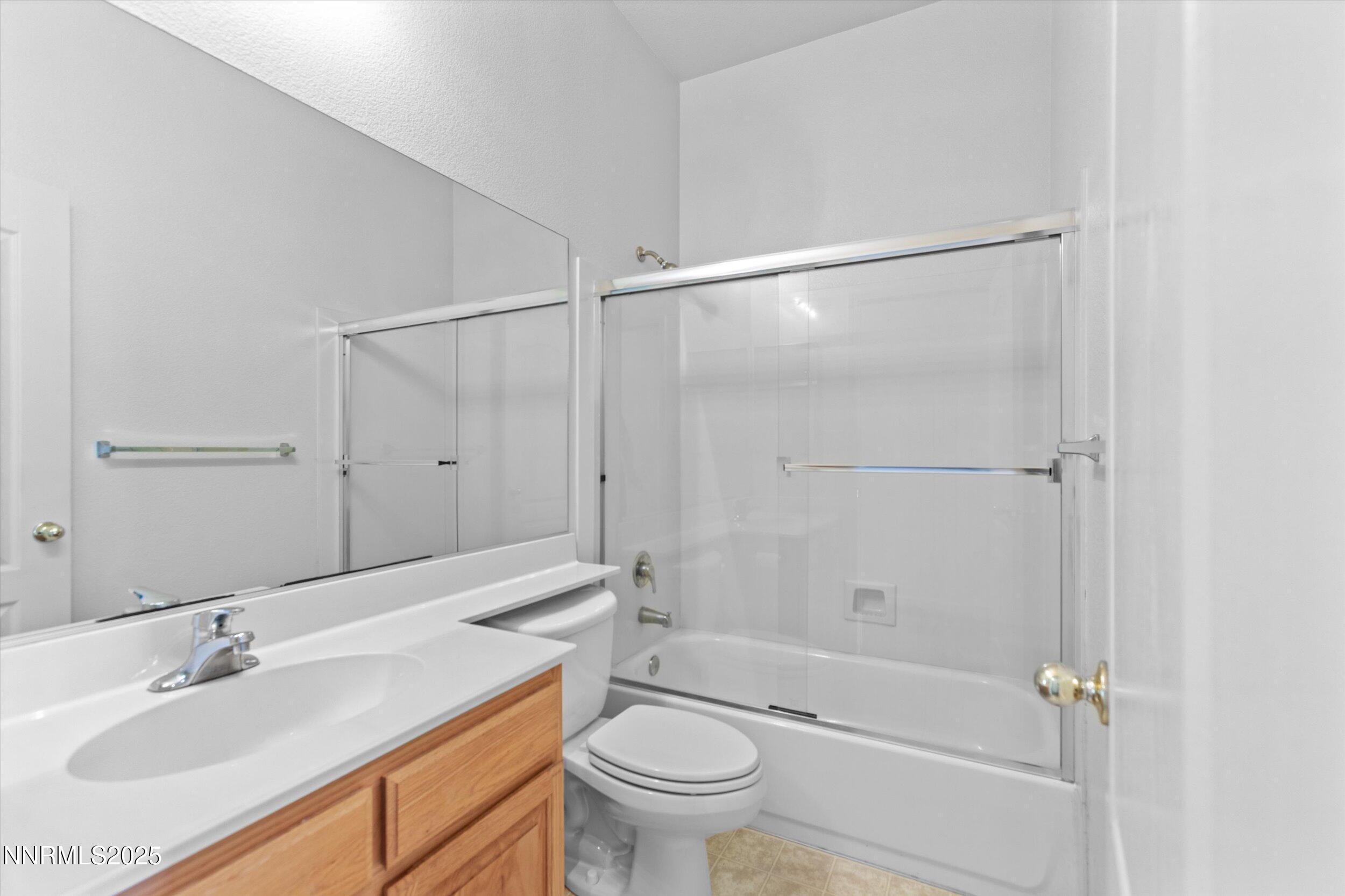 2365 Red Maple Court Reno, NV 89523 - Photo 30 of 34 a bathroom with a granite countertop sink a toilet and shower