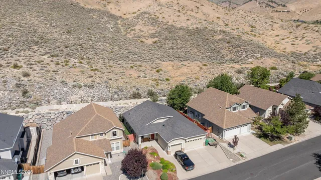 an aerial view of a house with a yard