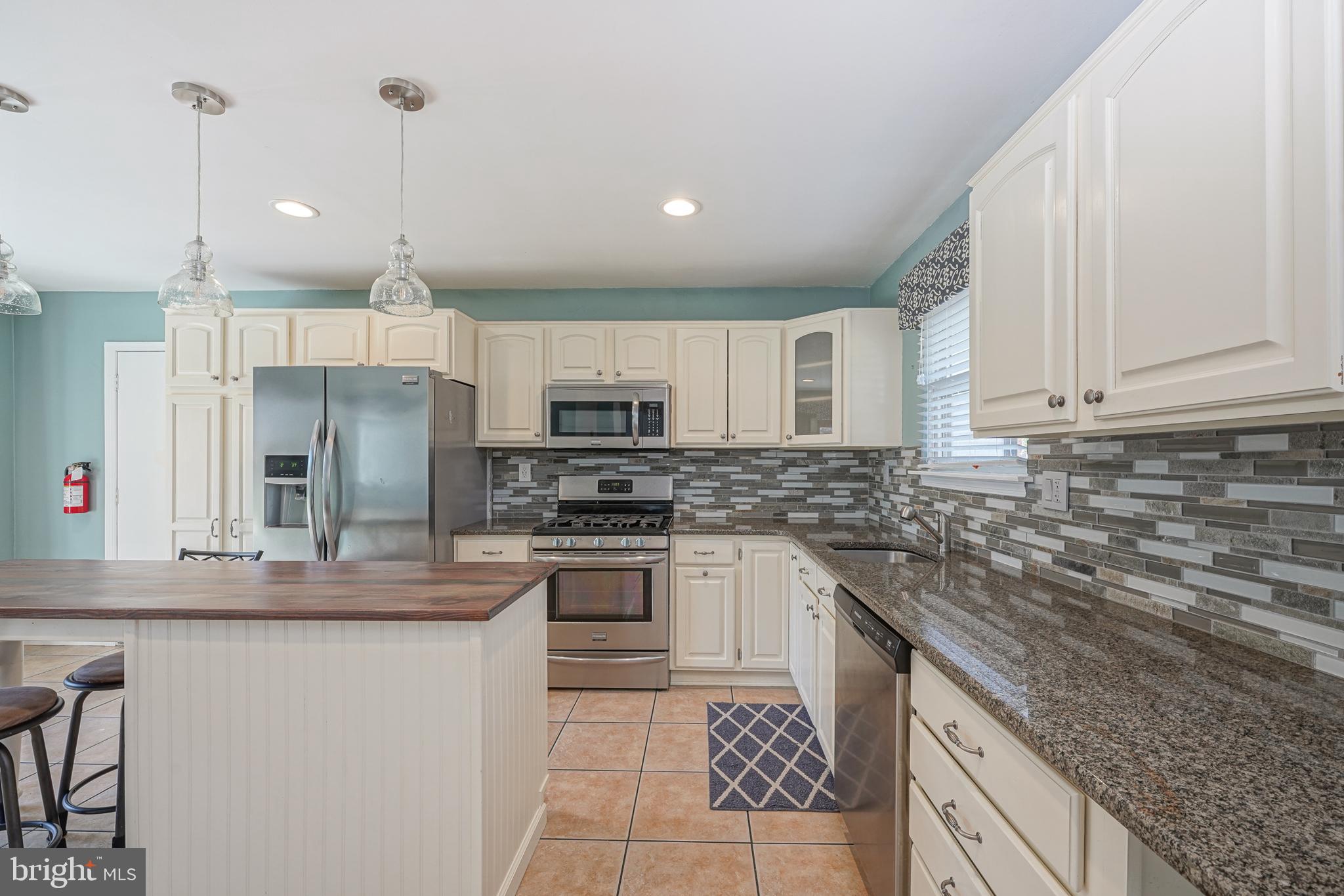 10 Gladstone Road Marlton, NJ 08053 - Photo 11 of 28 a kitchen with stainless steel appliances granite countertop a sink a stove a refrigerator and cabinets