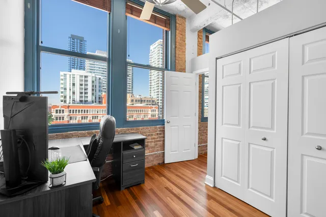 a view of a workspace with furniture and wooden floor