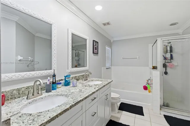 a bathroom with a granite countertop sink mirror vanity and bathtub