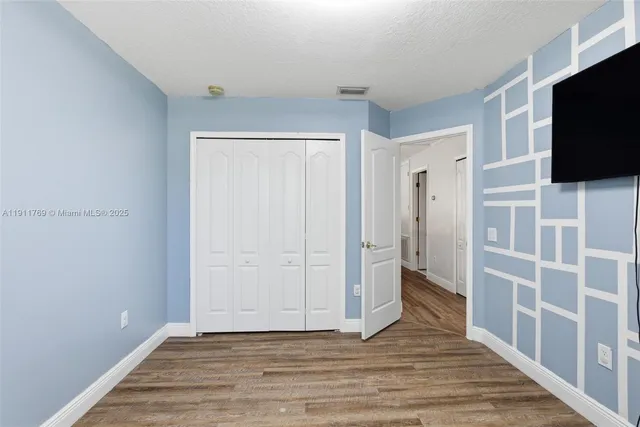 a view of a livingroom with an empty space & a flat screen tv