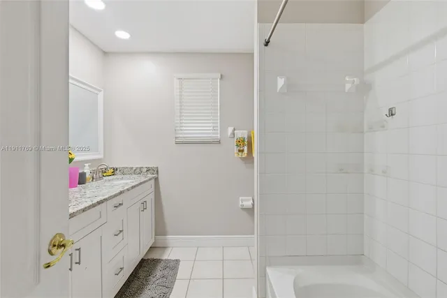 a bathroom with a double vanity sink and a shower