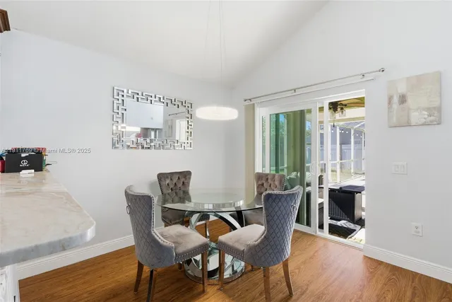 a dining room with furniture and wooden floor