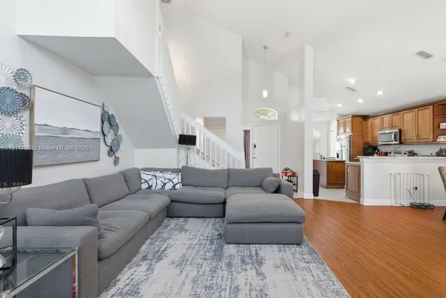 a living room with furniture and kitchen view