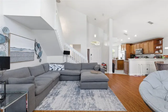 a living room with furniture and kitchen view