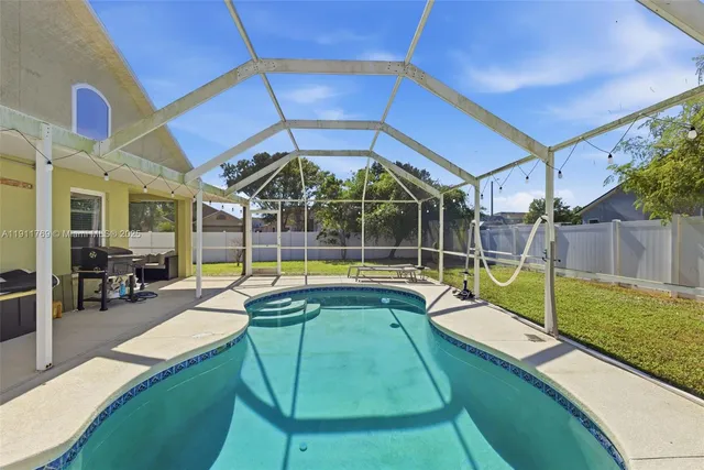 a view of swimming pool with seating area
