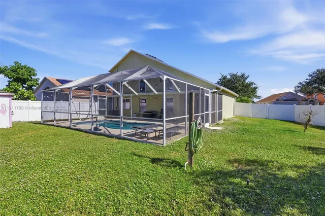 a view of a house with a yard and sitting area