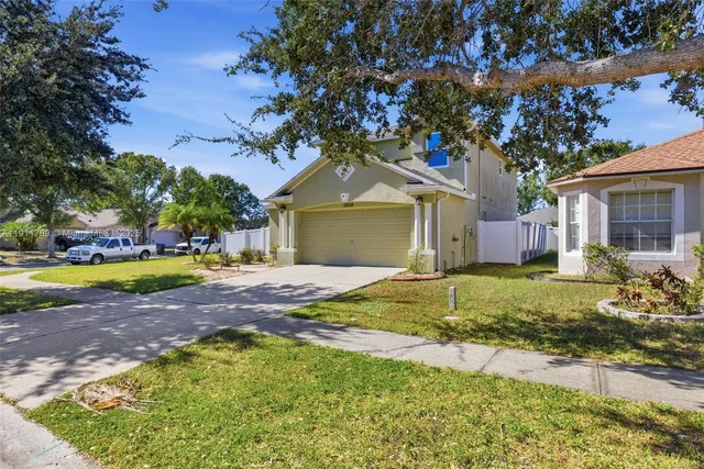 a front view of a house with a yard and garage