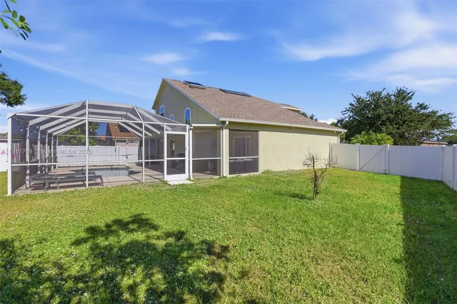 a view of an house with backyard space and balcony
