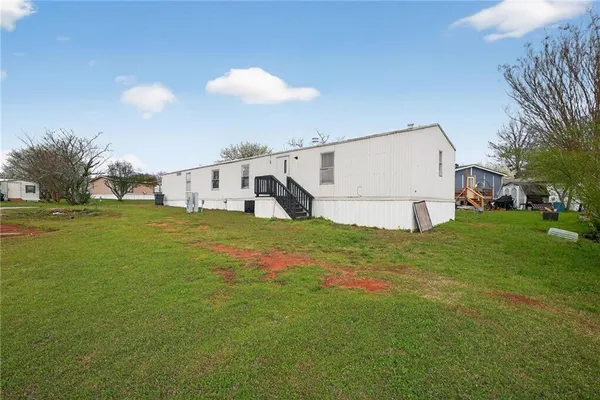 a view of a backyard with table and chairs and potted plants