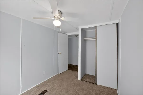 a view of an empty room with a fan