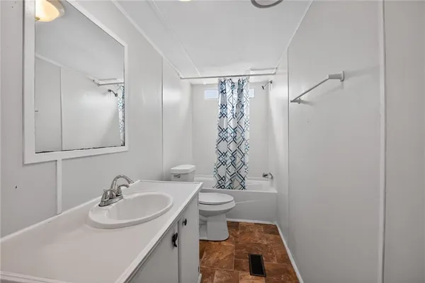 a bathroom with a sink toilet and a mirror