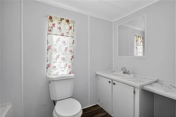 a bathroom with a toilet sink and mirror