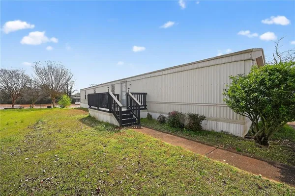 a backyard of a house with table and chairs