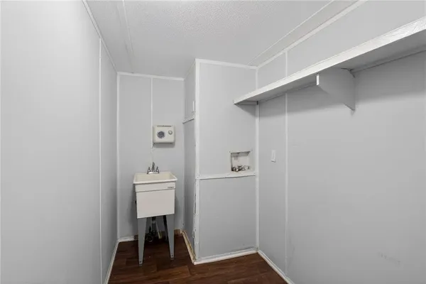 a view of hallway with a closet and a mirror