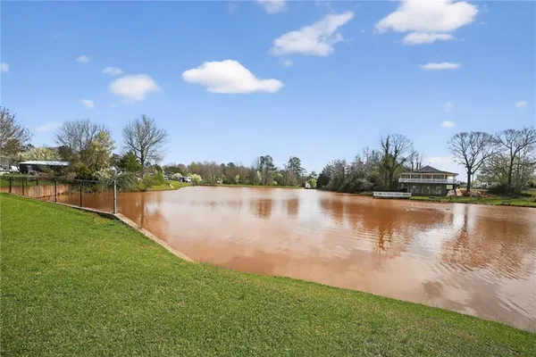 a view of a lake with houses in the back