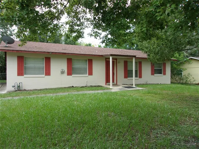 a front view of house with yard and green space
