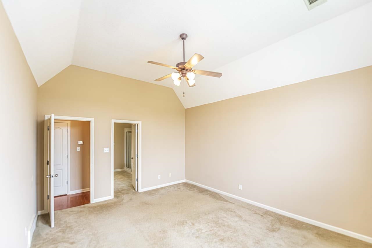 260 Terry Road Oakland, TN 38068 - Photo 18 of 33 Master bedroom with lofted ceiling, carpet floors, and ceiling fan