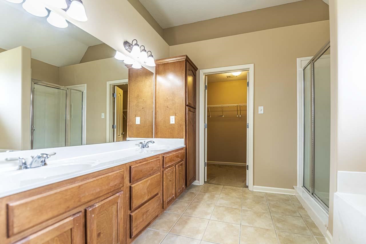 260 Terry Road Oakland, TN 38068 - Photo 20 of 33 Bathroom with dual vanity, tile patterned flooring, and walk in shower