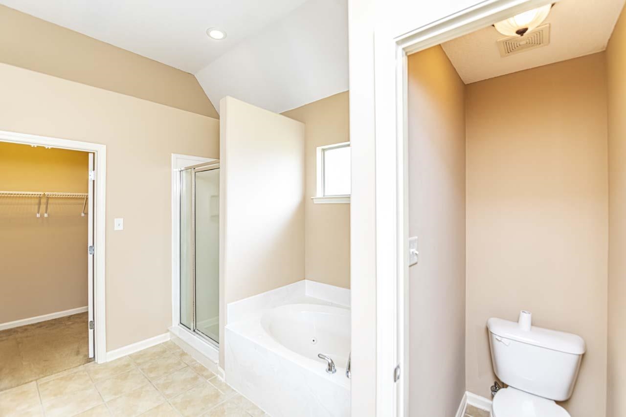 260 Terry Road Oakland, TN 38068 - Photo 21 of 33 Bathroom with tile patterned flooring, lofted ceiling, separate shower and tub, and toilet
