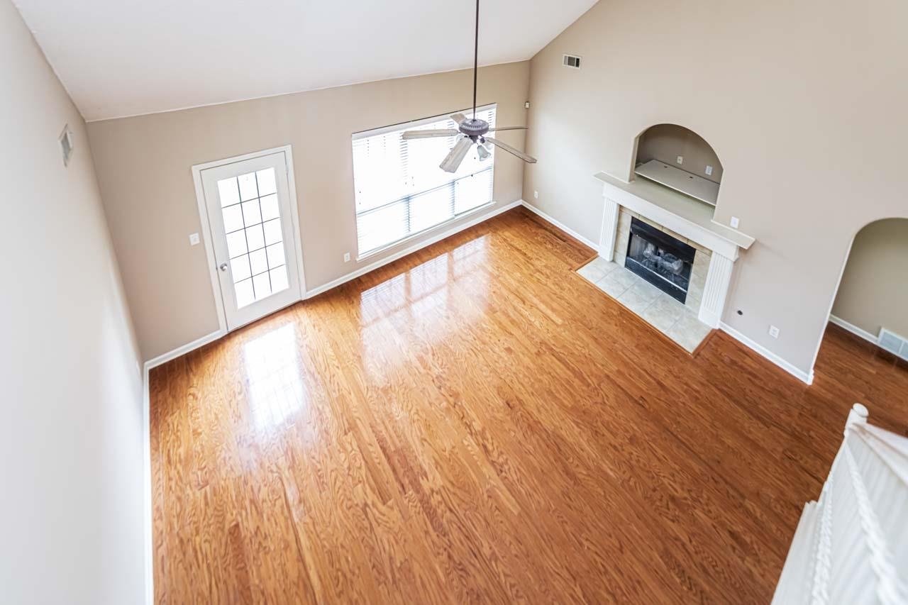 260 Terry Road Oakland, TN 38068 - Photo 9 of 33 living room with wood-type flooring, ceiling fan, high vaulted ceiling, and a tiled fireplace