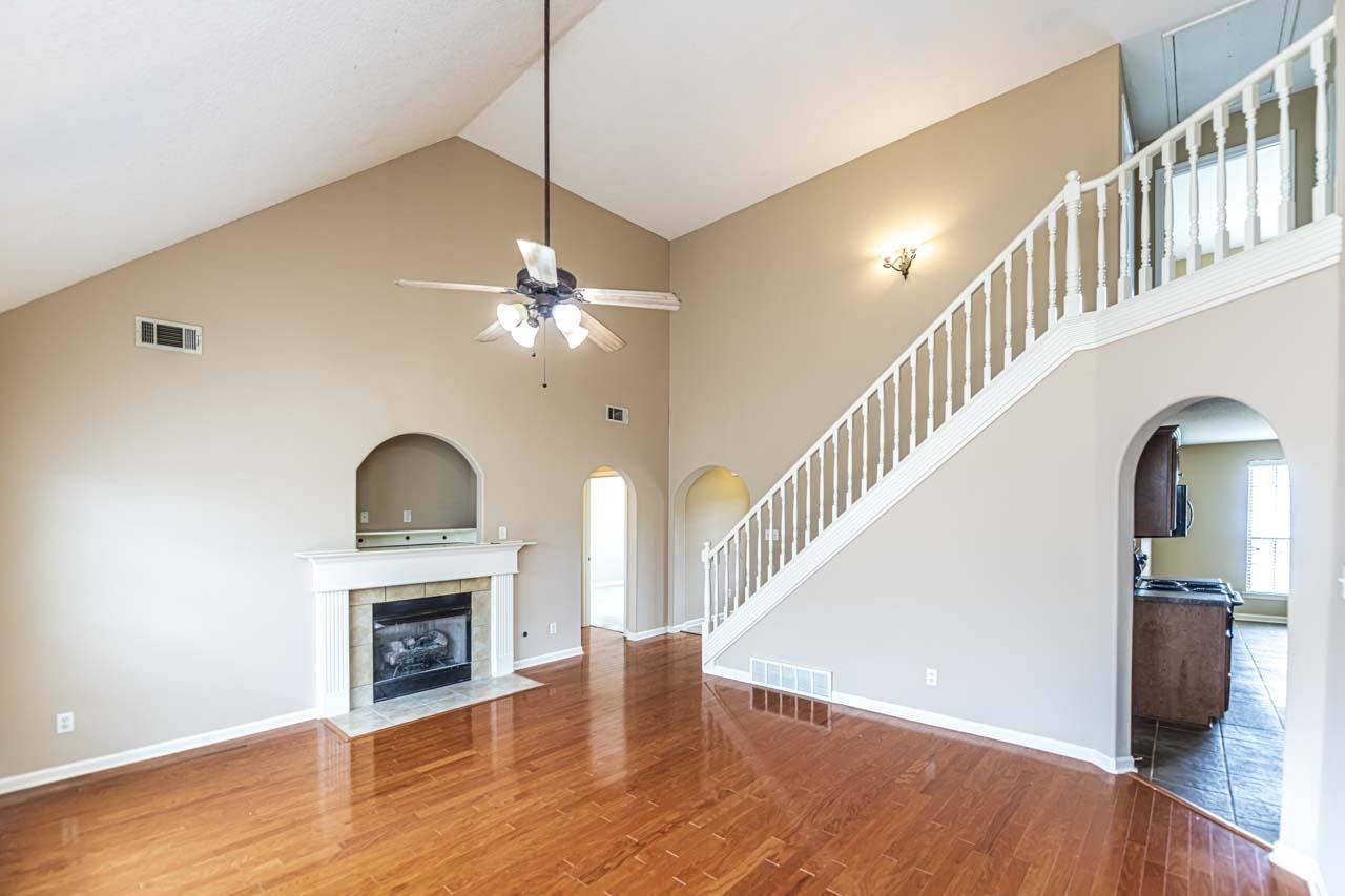 260 Terry Road Oakland, TN 38068 - Photo 10 of 33 living room with a tile fireplace, high vaulted ceiling, ceiling fan, and hardwood / wood-style floors