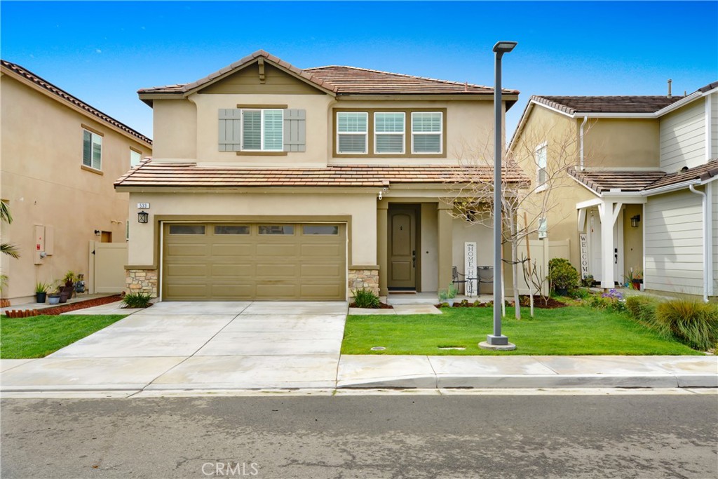 533 East Fromer Street Rialto, CA 92376 - Photo 1 of 1 a front view of a house with a yard and garage