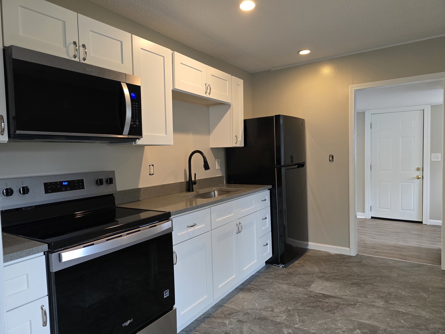 404 South Poplar Street Urbana, IL 61802 - Photo 4 of 12 a kitchen with stainless steel appliances a stove a microwave a sink and cabinets