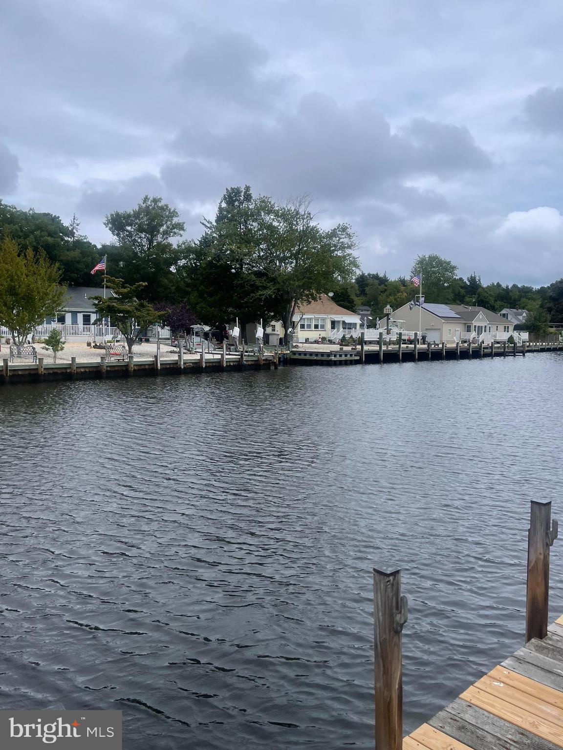 45 Cedar Run Road Bayville, NJ 08721 - Photo 4 of 10 a view of a lake with beach and city view