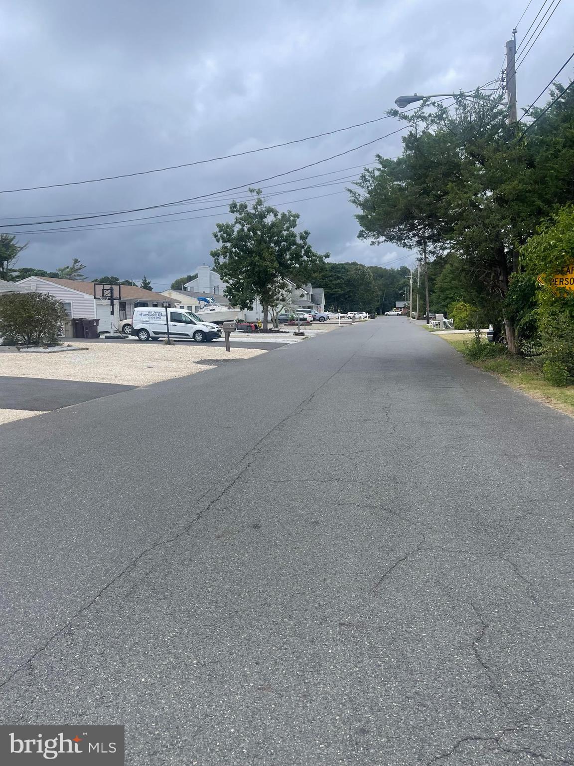 45 Cedar Run Road Bayville, NJ 08721 - Photo 9 of 10 a view of a street with a cars parked on the road