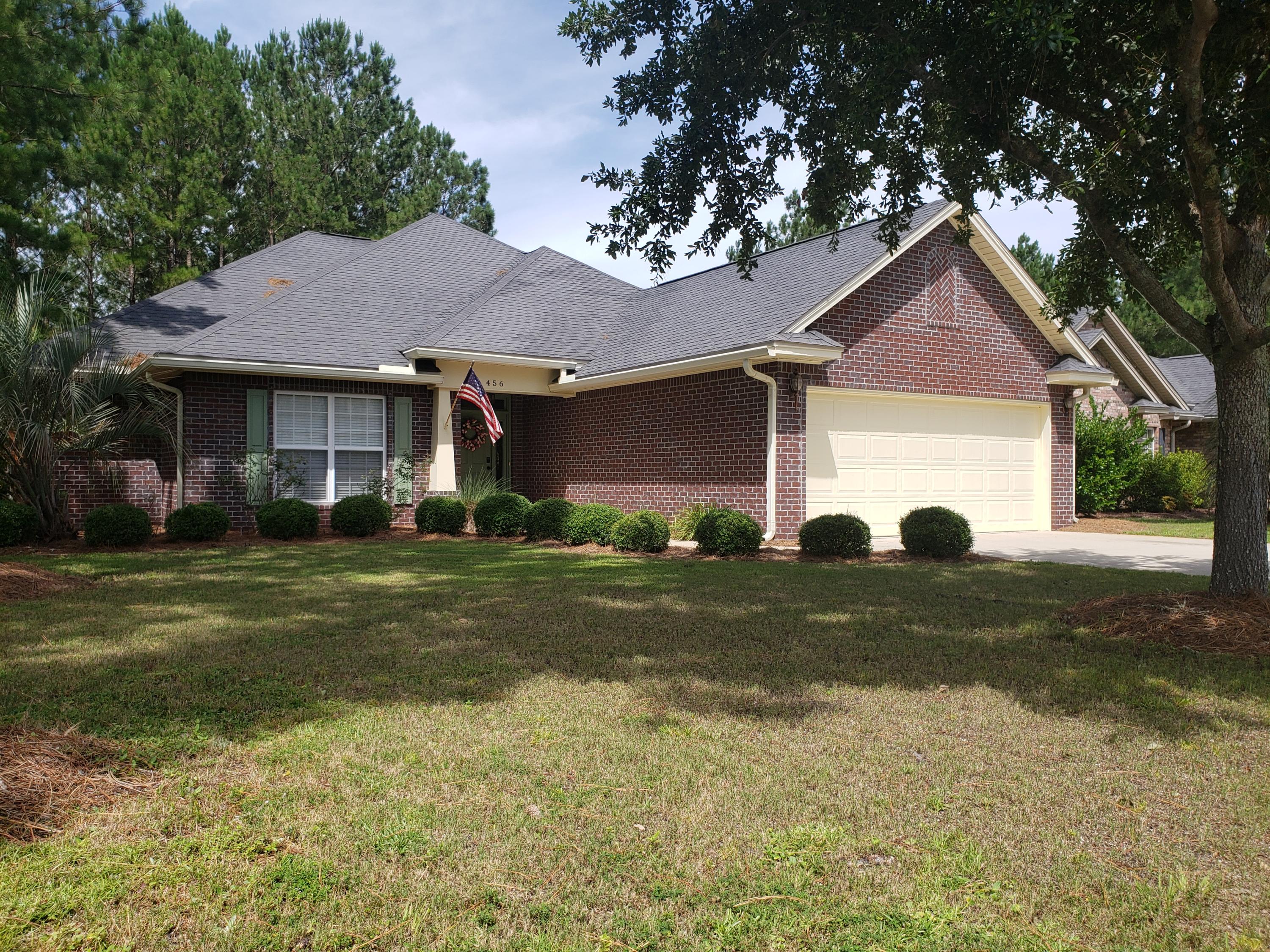 a front view of house with yard and green space