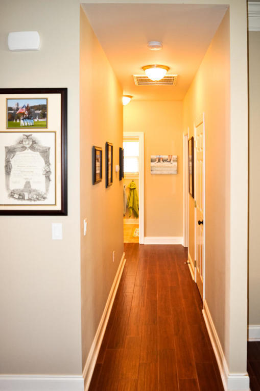 456 Windchime Way Freeport, FL 32439 - Photo 13 of 29 a view of a hallway with wooden floor and a bathroom