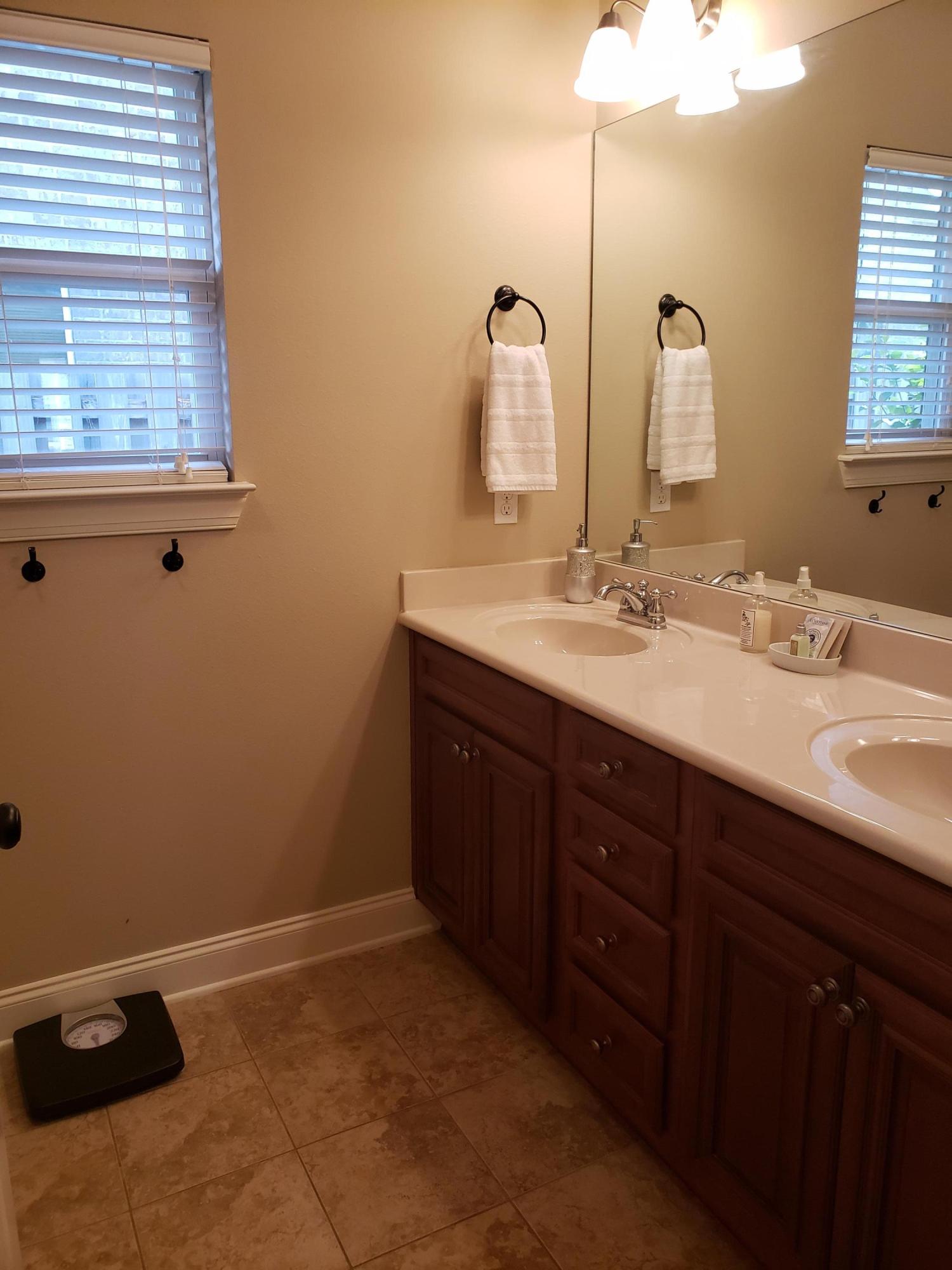 456 Windchime Way Freeport, FL 32439 - Photo 17 of 29 a bathroom with a double vanity sink and a mirror