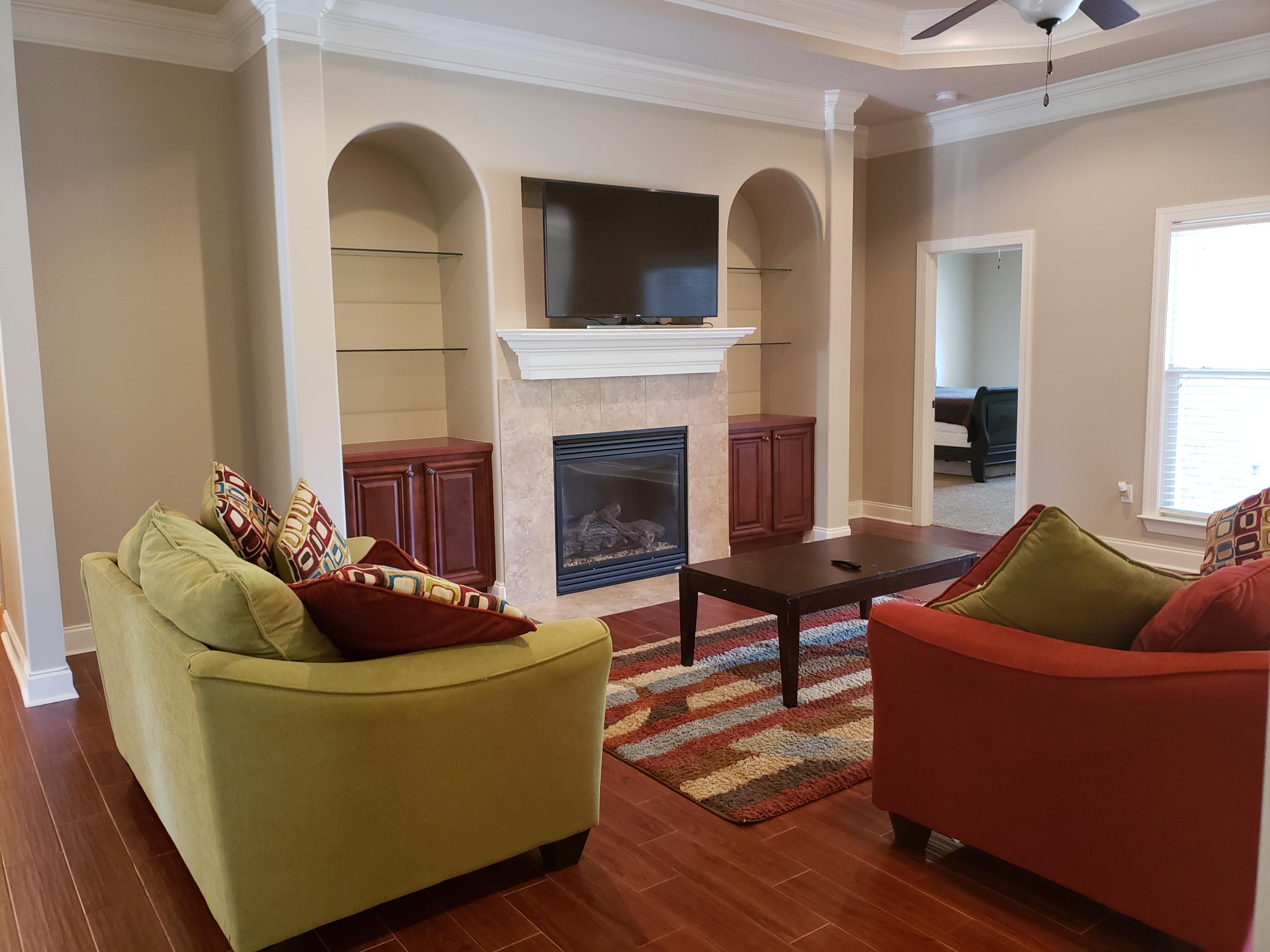 456 Windchime Way Freeport, FL 32439 - Photo 4 of 29 a living room with furniture and a fireplace