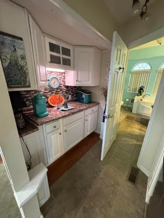 a view of a porch with furniture and floor to ceiling window
